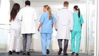 Faculty walking together down a hallway.